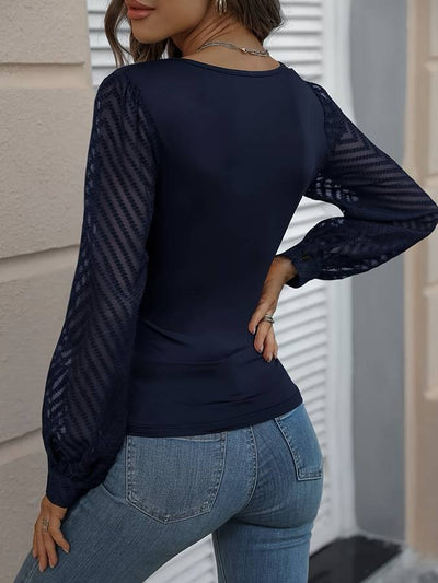 Isabella

 Deep V-neck top with mesh sleeves