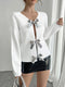 Quincy | Elegante V-hals Trui met Pailletten Strikjes